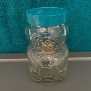 VINTAGE SKIPPY PEANUT BUTTER FIGURAL GLASS BEAR SHAPED JAR BLUE LID EMPTY 7” H